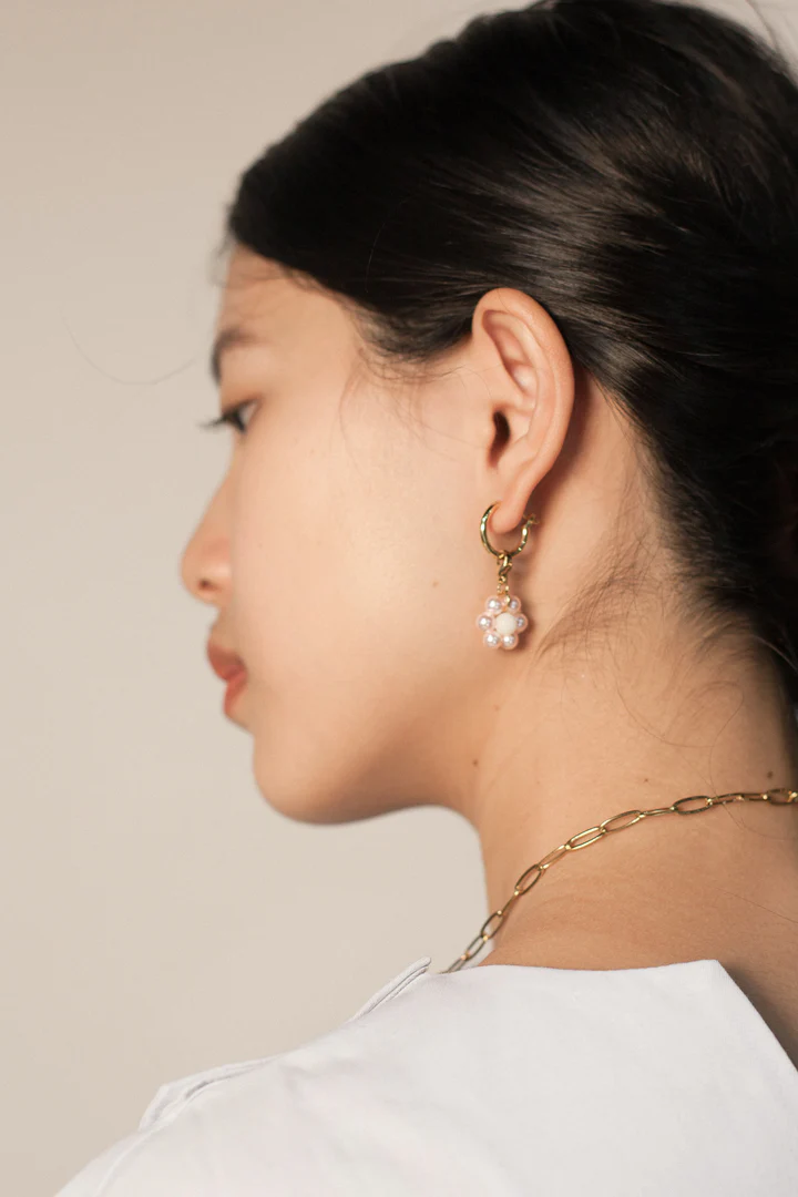 cherry blossom charm shown fitted to mini hoop earring worn by model